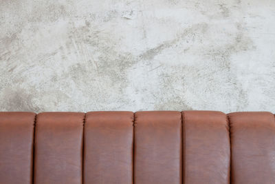 Close-up of sofa against white wall