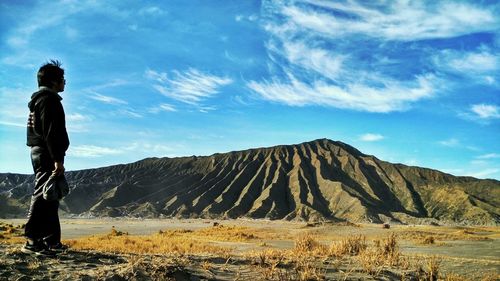 Man standing on field against mount bromo
