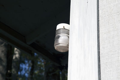 Globe and light turned off on the side of a house