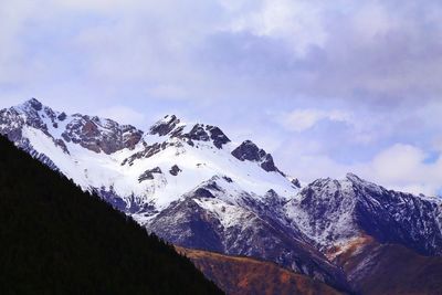 Scenic view of snow covered mountains against sky