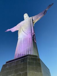 Low angle view of statue against clear blue sky