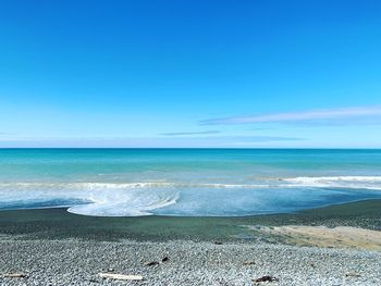 Scenic view of sea against blue sky