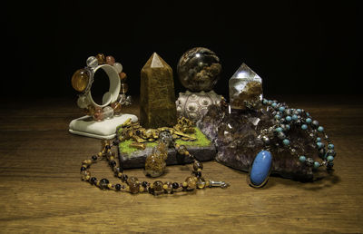 Close-up of ring on table against black background