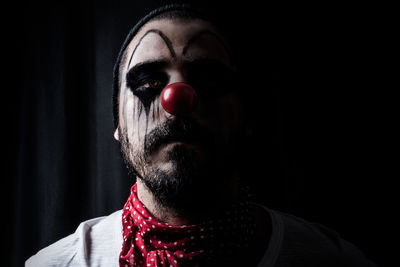 Close-up of man with halloween make-up standing in darkroom