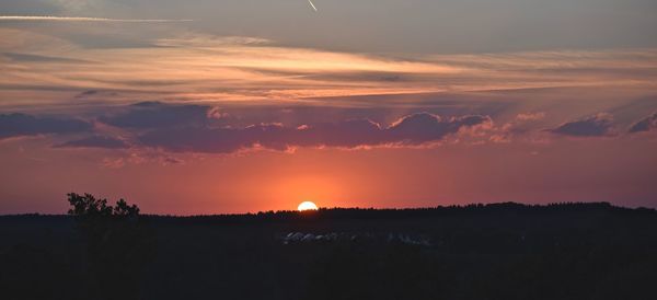 Dramatic sky over silhouette landscape