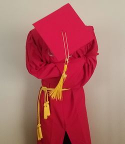 Close-up of hand holding red umbrella