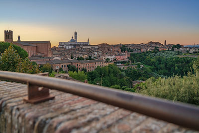 Cityscape against clear sky during sunset