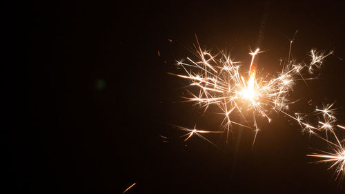 Low angle view of firework display at night