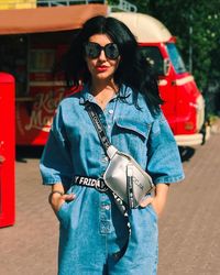 Young woman wearing sunglasses standing outdoors