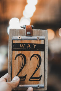 Close-up of person holding number 22 sign