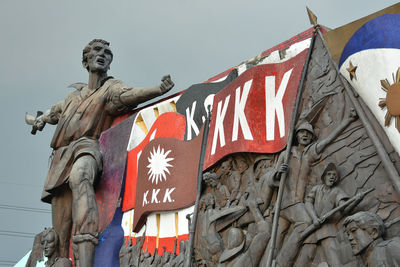 Low angle view of statue against sky