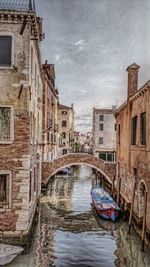 Boats in canal with buildings in background