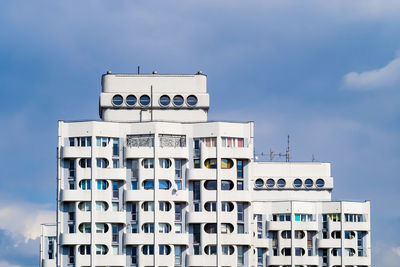 Low angle view of building against cloudy sky