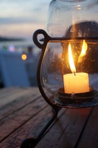 Close-up of lit candle on table