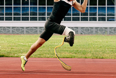 Low section of man exercising on field