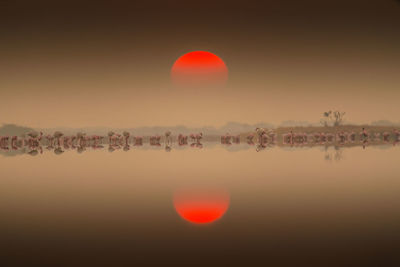 Scenic view of lake against sky during sunset