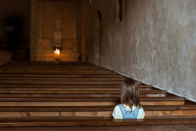 Girl sitting in church 