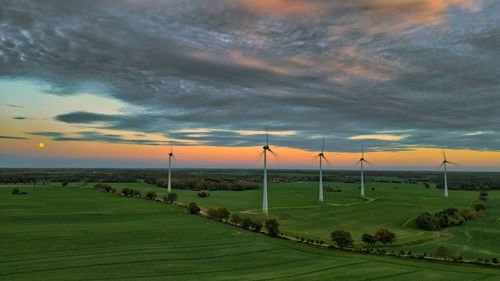 Scenic view of field against sky during sunset