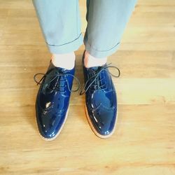 Low section of person standing on hardwood floor