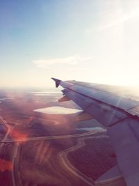 Cropped image of airplane flying over landscape