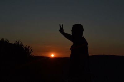 Silhouette people at sunset