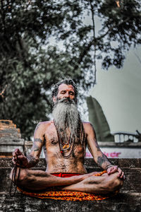 Full length of man sitting at temple