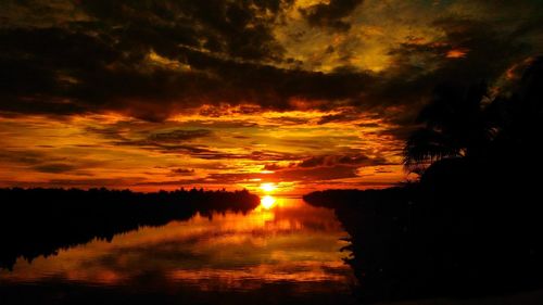 Scenic view of lake against orange sky