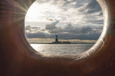 Statue of sea against cloudy sky