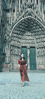 Portrait of man standing against temple outside building
