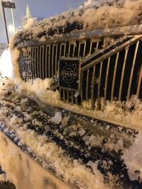 Close-up of rusty car on snow covered land