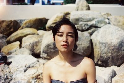 Portrait of young woman on rock