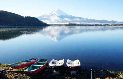 High angle view of lake and mountains against clear sky