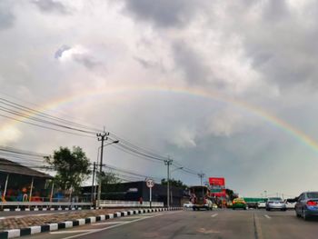 View of rainbow over city street
