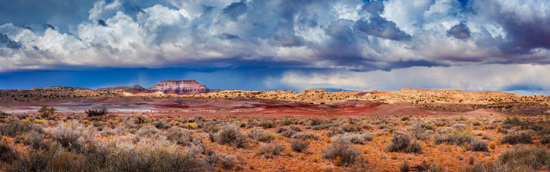 Panoramic view of landscape against storm clouds