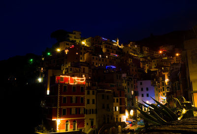 Illuminated buildings against sky at night