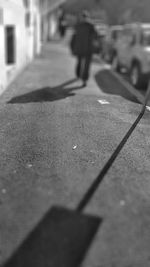 Surface level of man walking on street in city