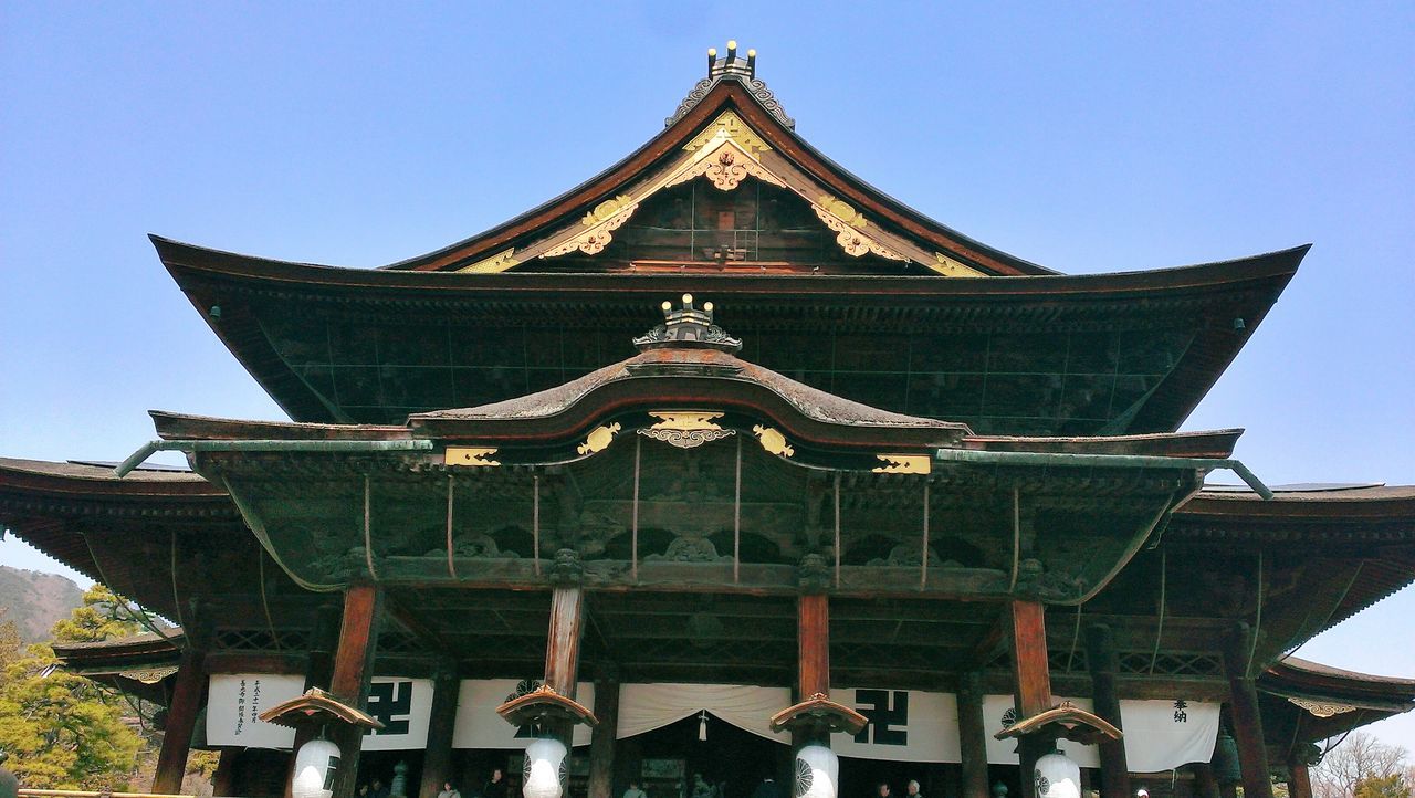 place of worship, religion, architecture, built structure, building exterior, spirituality, low angle view, temple - building, clear sky, roof, church, temple, sky, blue, sunlight, day, travel destinations, tradition