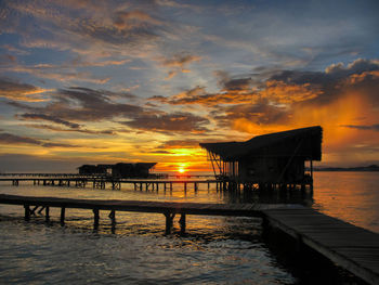 Silhouette pier on sea against sky during sunset