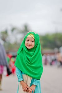 Portrait of innocent girl wearing green hijab