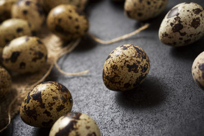 Quail eggs on a black table.