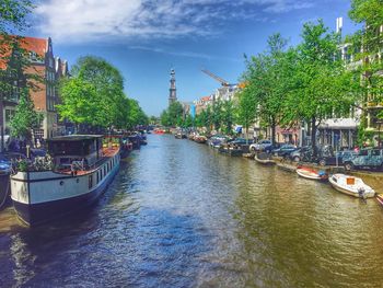 Boats in river with buildings in background