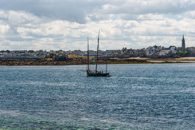 Sailboat sailing on sea against sky