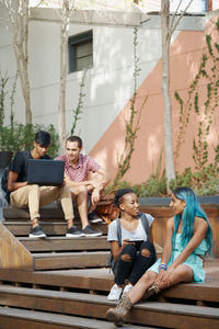 Young friends sitting on steps