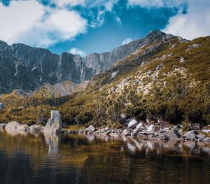 Scenic view of lake and mountains against sky