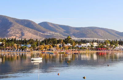 Scenic view of lake and mountains against clear sky