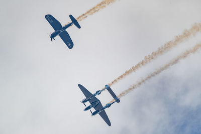 Low angle view of airplane flying in sky