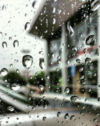 Full frame shot of wet glass window in rainy season