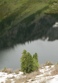 High angle view of mountain reflecting in lake during winter