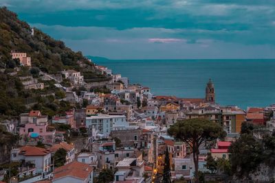 High angle view of townscape by sea against sky