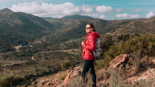 Portrait of man standing on mountain against sky